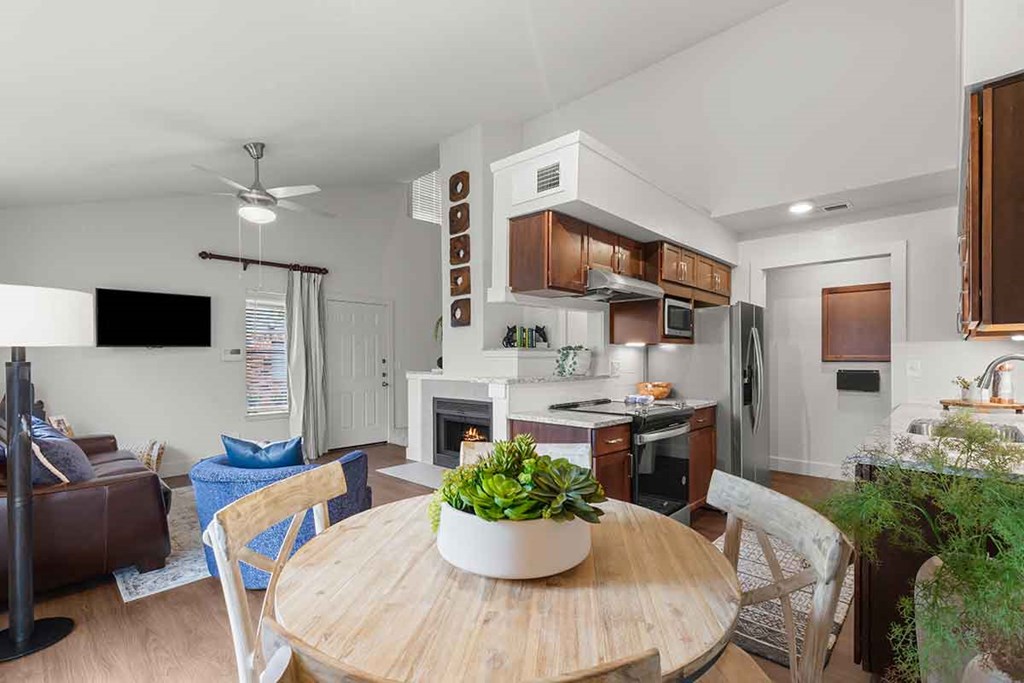 a kitchen and dining room with a table and chairs