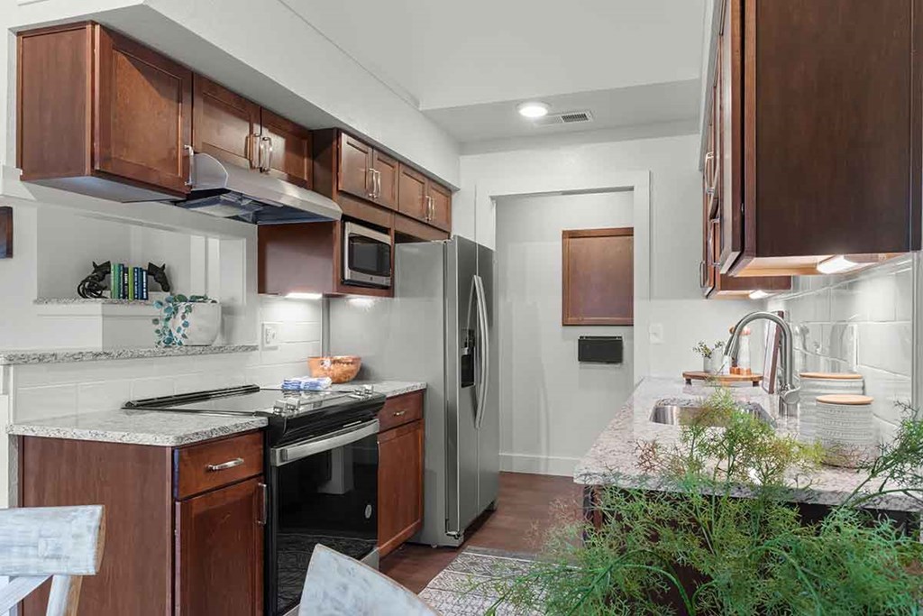a kitchen with stainless steel appliances and wooden cabinets