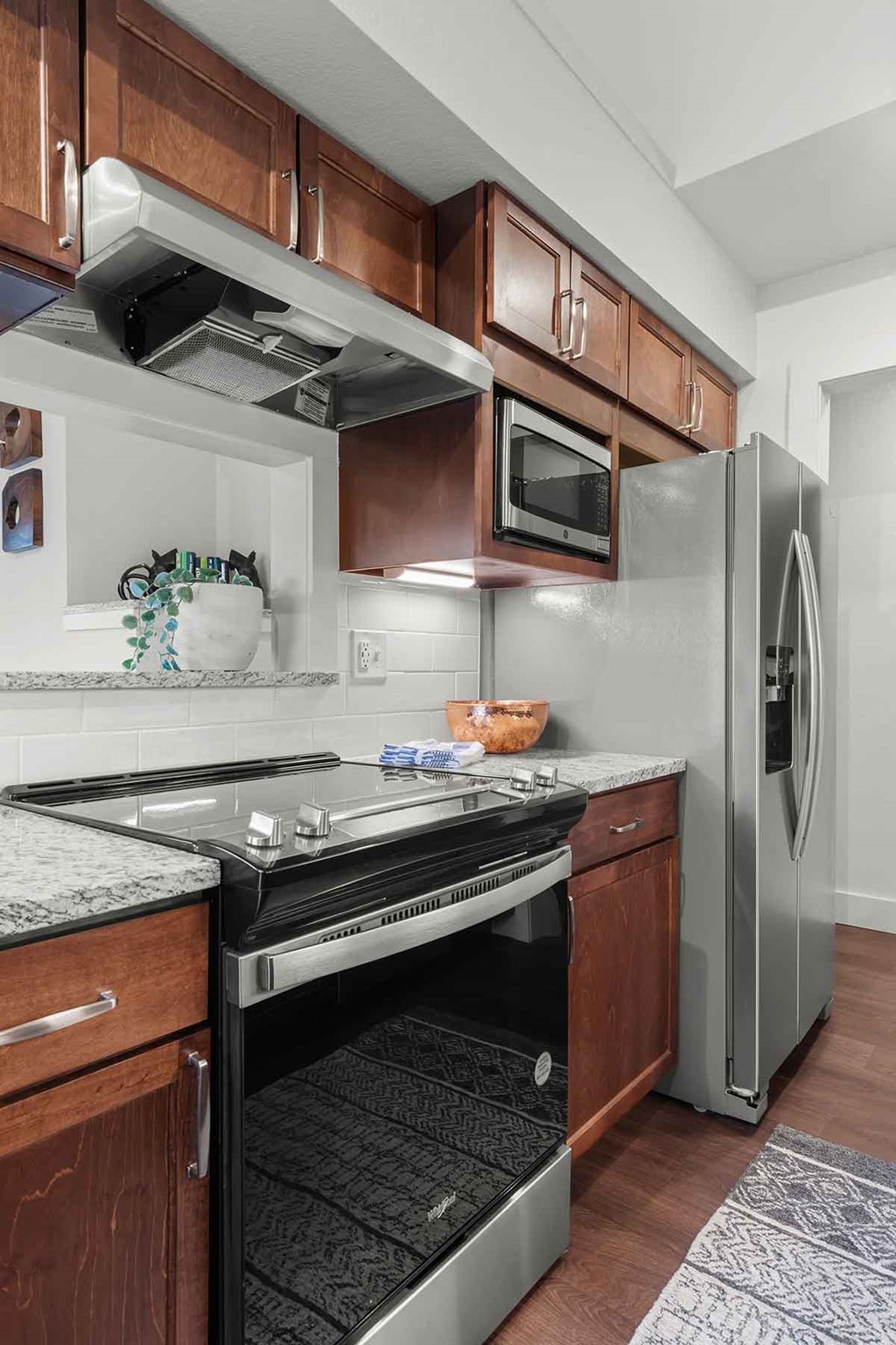 a kitchen with stainless steel appliances and wooden cabinets