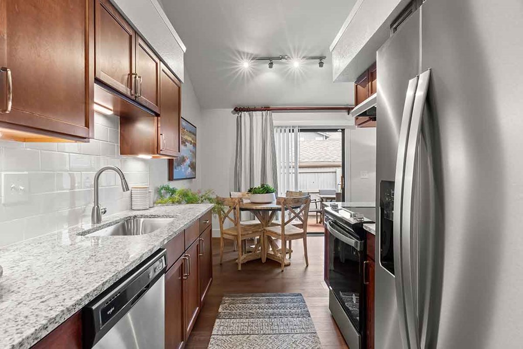 a kitchen with stainless steel appliances and a counter top