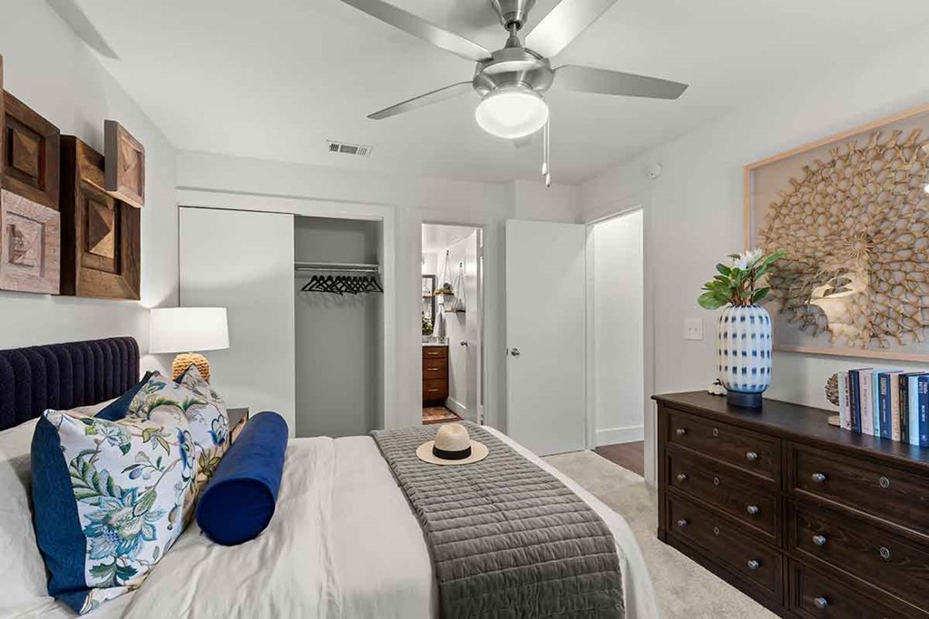 a bedroom with a bed and a ceiling fan