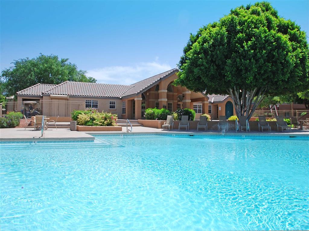 a large swimming pool with a building in the background