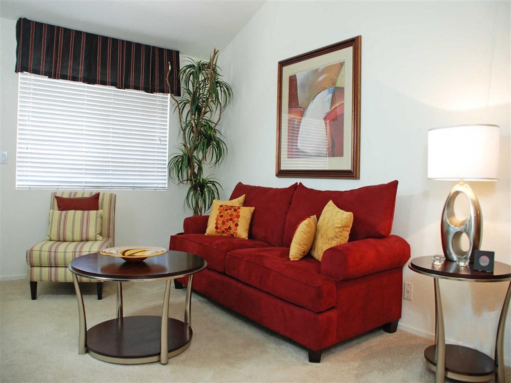 a living room with a red couch and a table