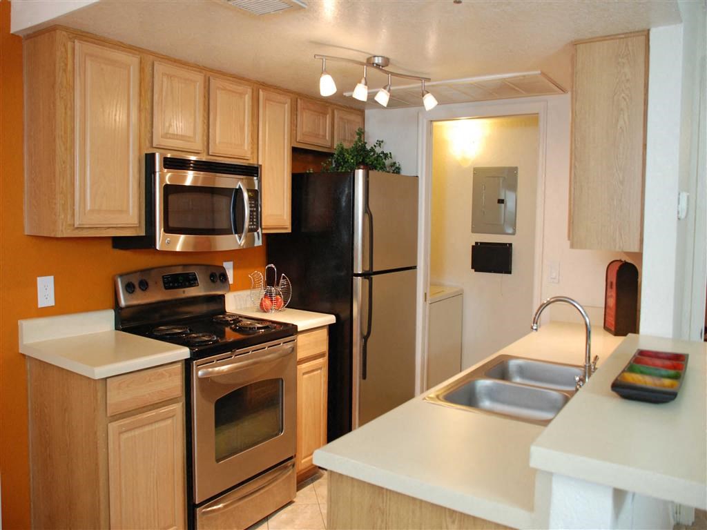 a kitchen with stainless steel appliances and wooden cabinets