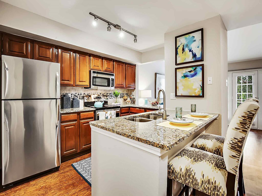 a kitchen with stainless steel appliances and granite counter tops