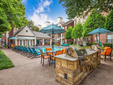 a resort style pool and patio with chairs and umbrellas