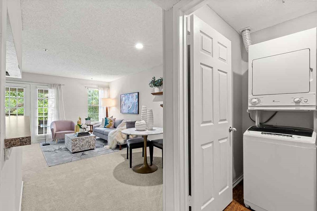 a white living room with a white refrigerator and a tv