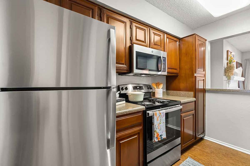 a kitchen with stainless steel appliances and wooden cabinets