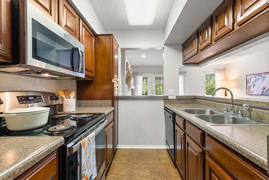 a kitchen with a sink and a stove and a microwave