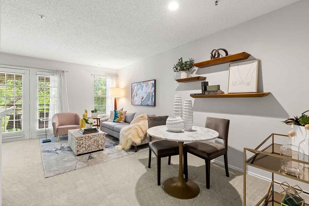 a living room with a table and chairs and a couch