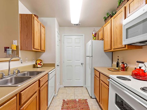 a kitchen with a sink and a refrigerator