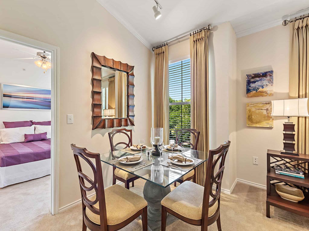a dining room with a table and chairs