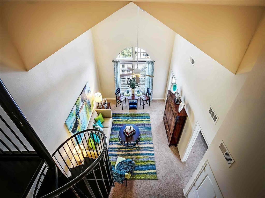a view of a living room from the top of a staircase
