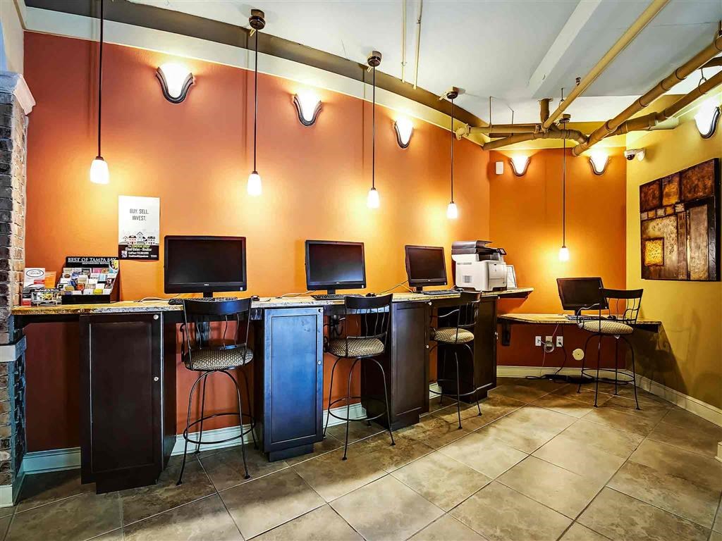 a computer room with three desks and three chairs