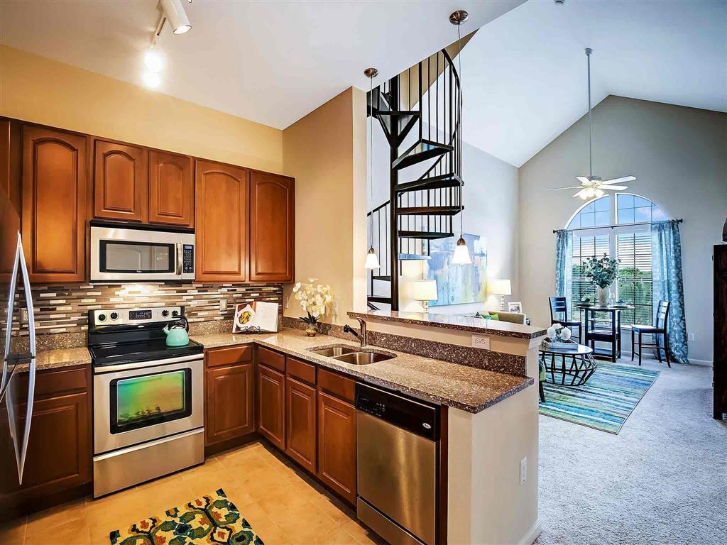 a kitchen with stainless steel appliances and granite counter tops
