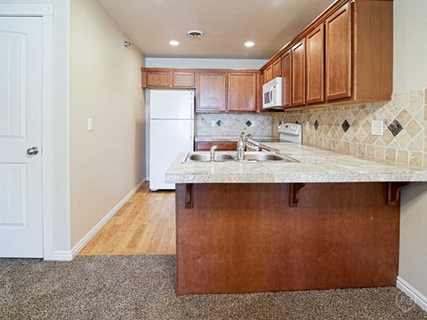 a kitchen with a sink and a refrigerator