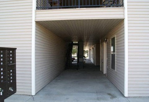 a hallway of a building with a long porch