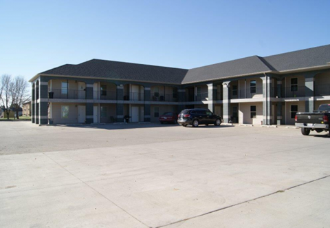 a large building with cars parked in front of it