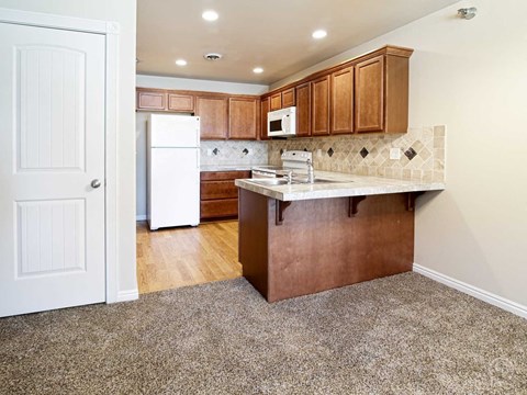 a kitchen with wooden cabinets and a white refrigerator