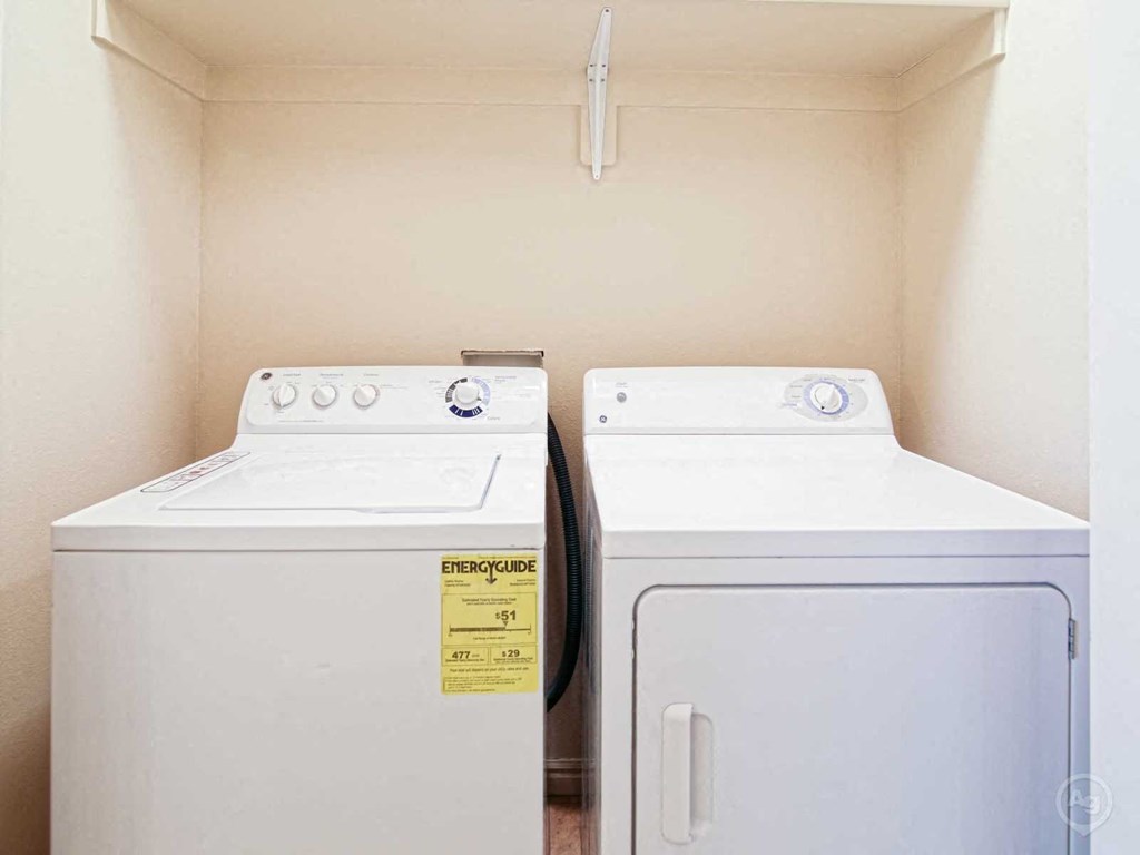 a washer and dryer in a laundry room with two washing machines
