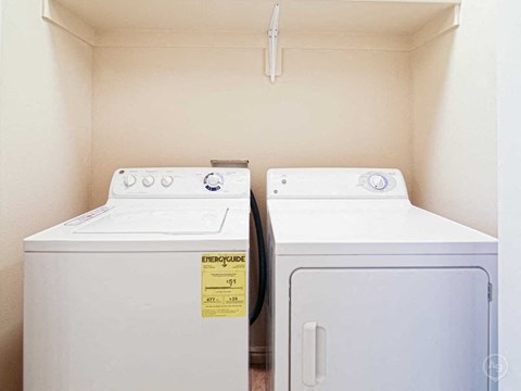 a washer and dryer in a laundry room with two washing machines