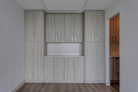 A kitchen with wooden cabinets and drawers.