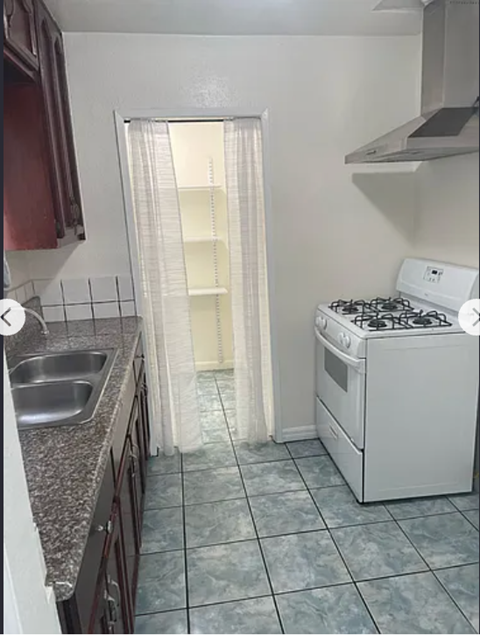 A small kitchen with a stove and sink.
