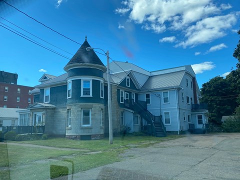 A large house with a tower-like structure on the roof.
