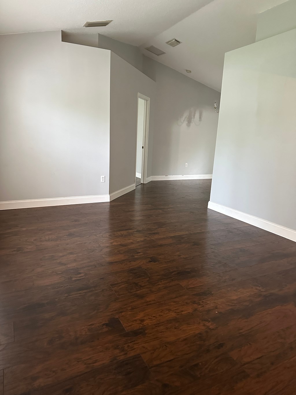 A room with wooden floors and white walls.