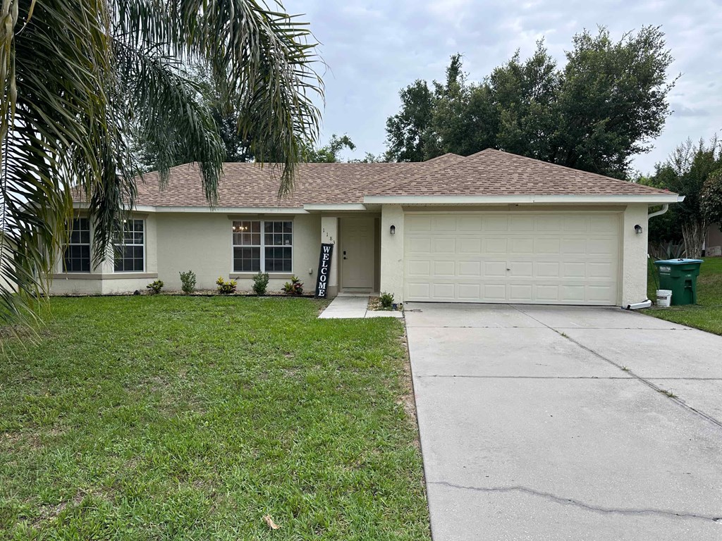 A house with a brown roof and a white garage door.