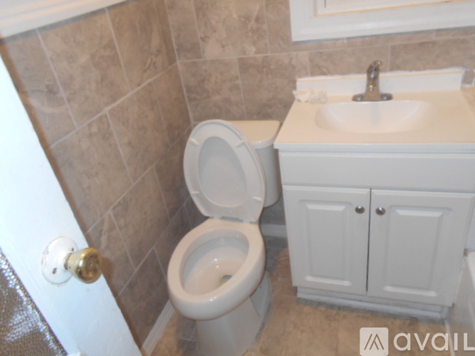 A white bathroom with a tub, sink, and toilet.