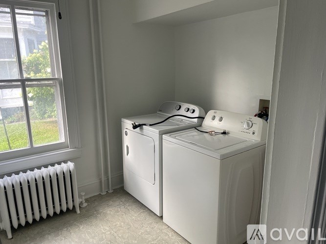 A white washing machine and dryer in a small laundry room.