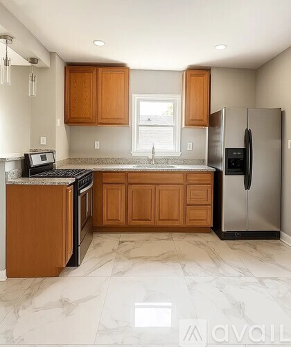 A bathroom with a white door and a white marble floor.