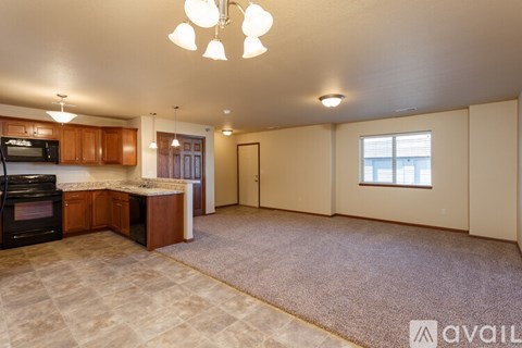 A kitchen with a microwave, oven, and cabinets.