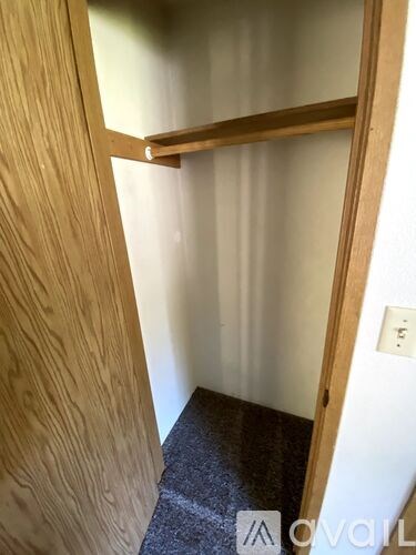 A small, dark room with a wooden door.