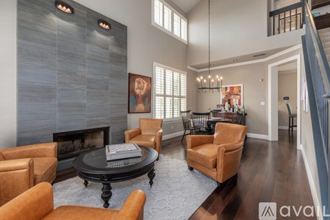 A living room with a fireplace and a painting on the wall.