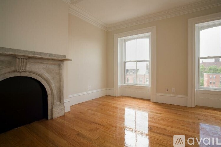A room with a fireplace and wooden floors.