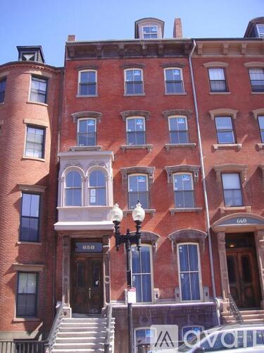 A red brick building with the number 650 on the front door.