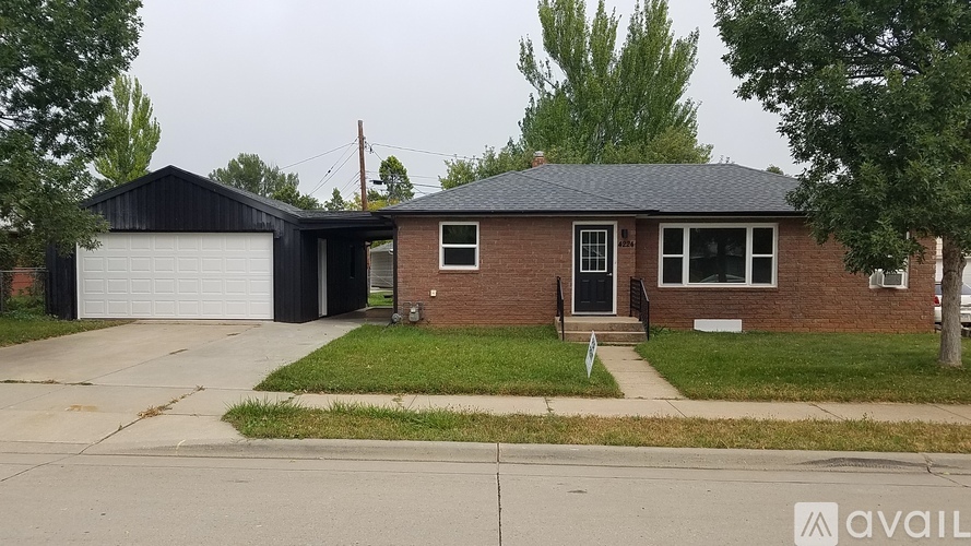 A house with a garage and a driveway in front.