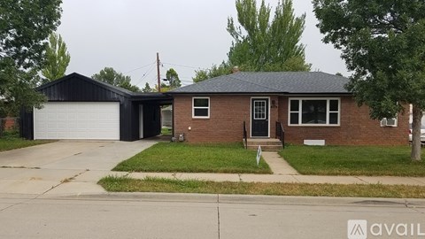 A house with a garage and a driveway in front.