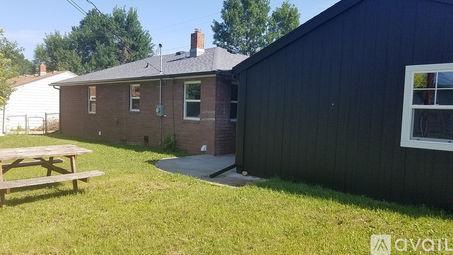 A house with a black exterior and a white window is for sale.