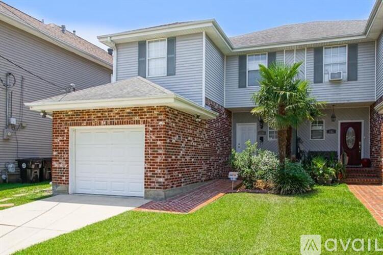 A house with a brick pillar and a garage door.