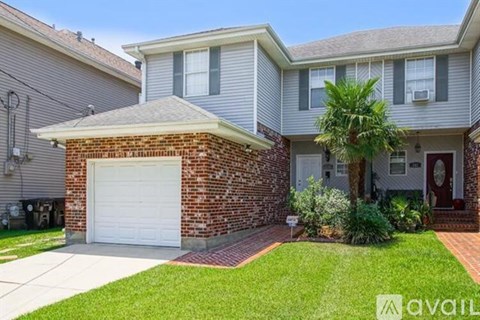 A house with a brick pillar and a garage door.