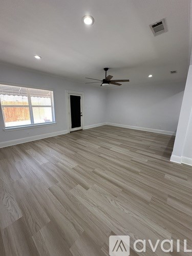 A room with a ceiling fan and light fixture.