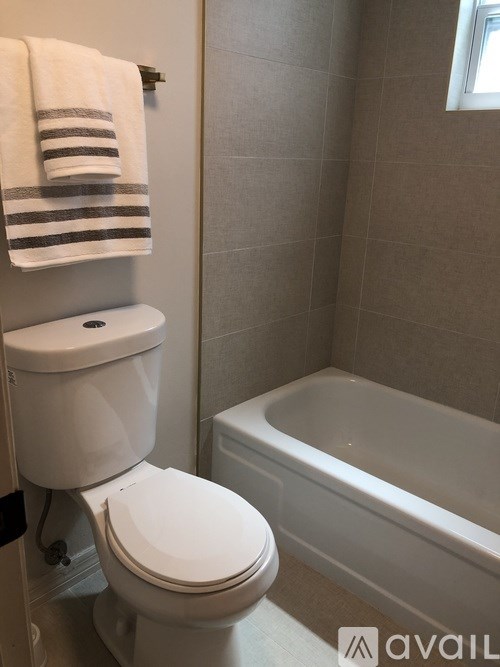 A white toilet with a white bathtub in a bathroom.