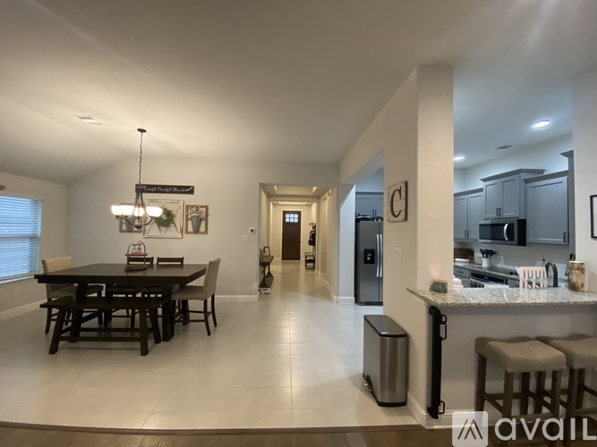 A modern kitchen with a dining table and chairs.