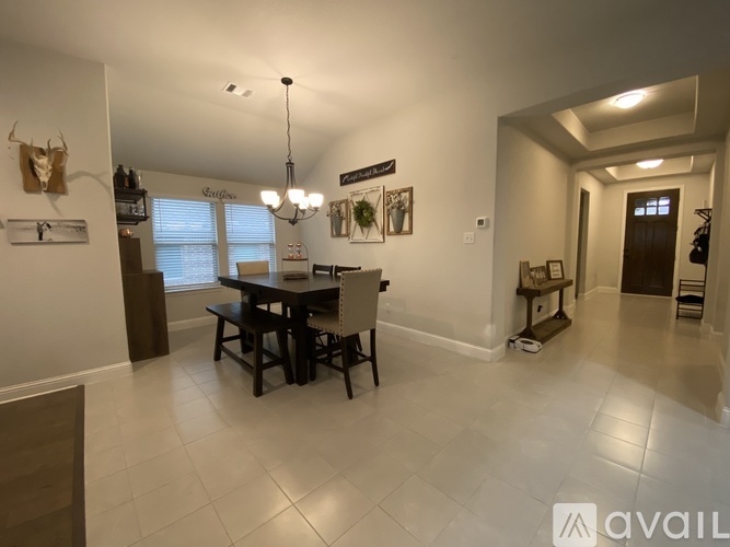 A dining room with a table and chairs.