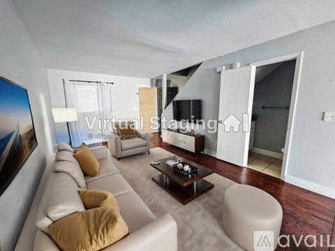 A modern living room with a white sofa and a wooden coffee table.