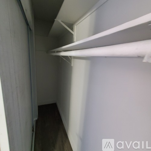 A long white shelf is mounted on a wall.