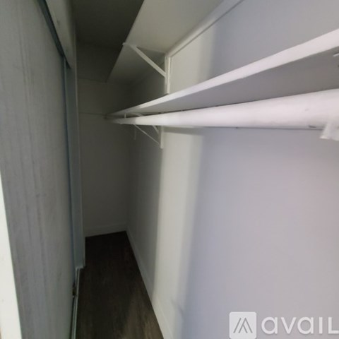A long white shelf is mounted on a wall.